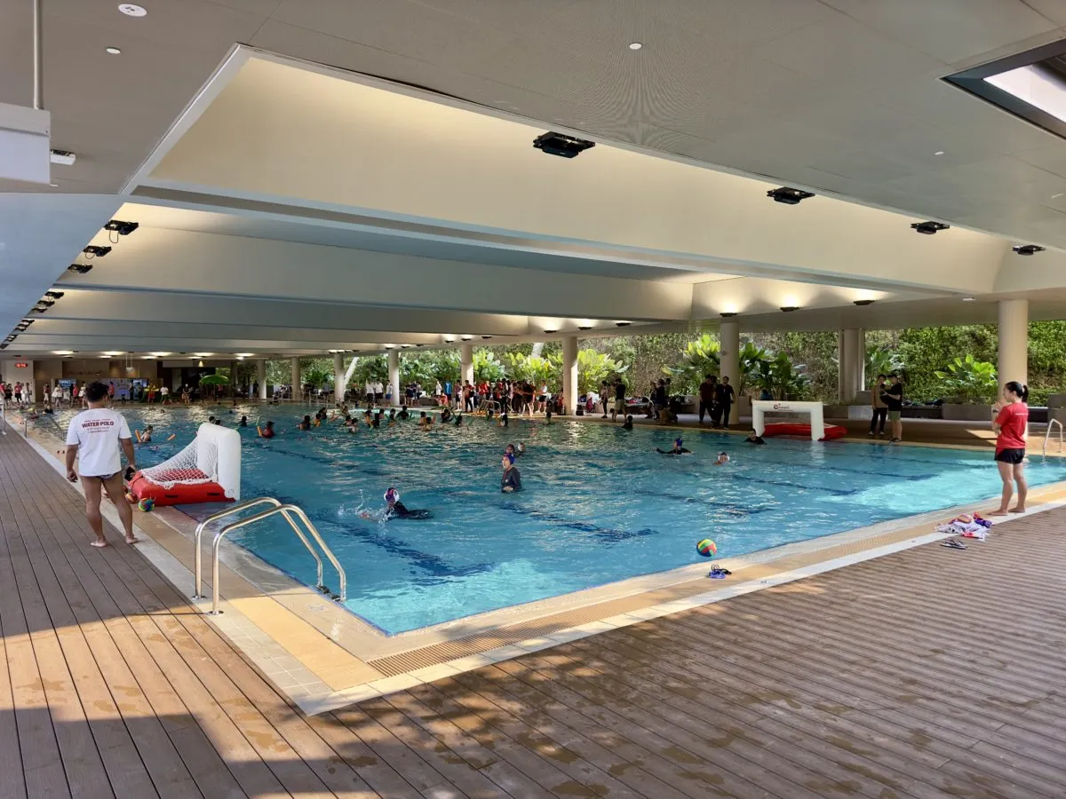 Sheltered 25-metre pool with swimmers at Bukit Canberra Swimming Complex